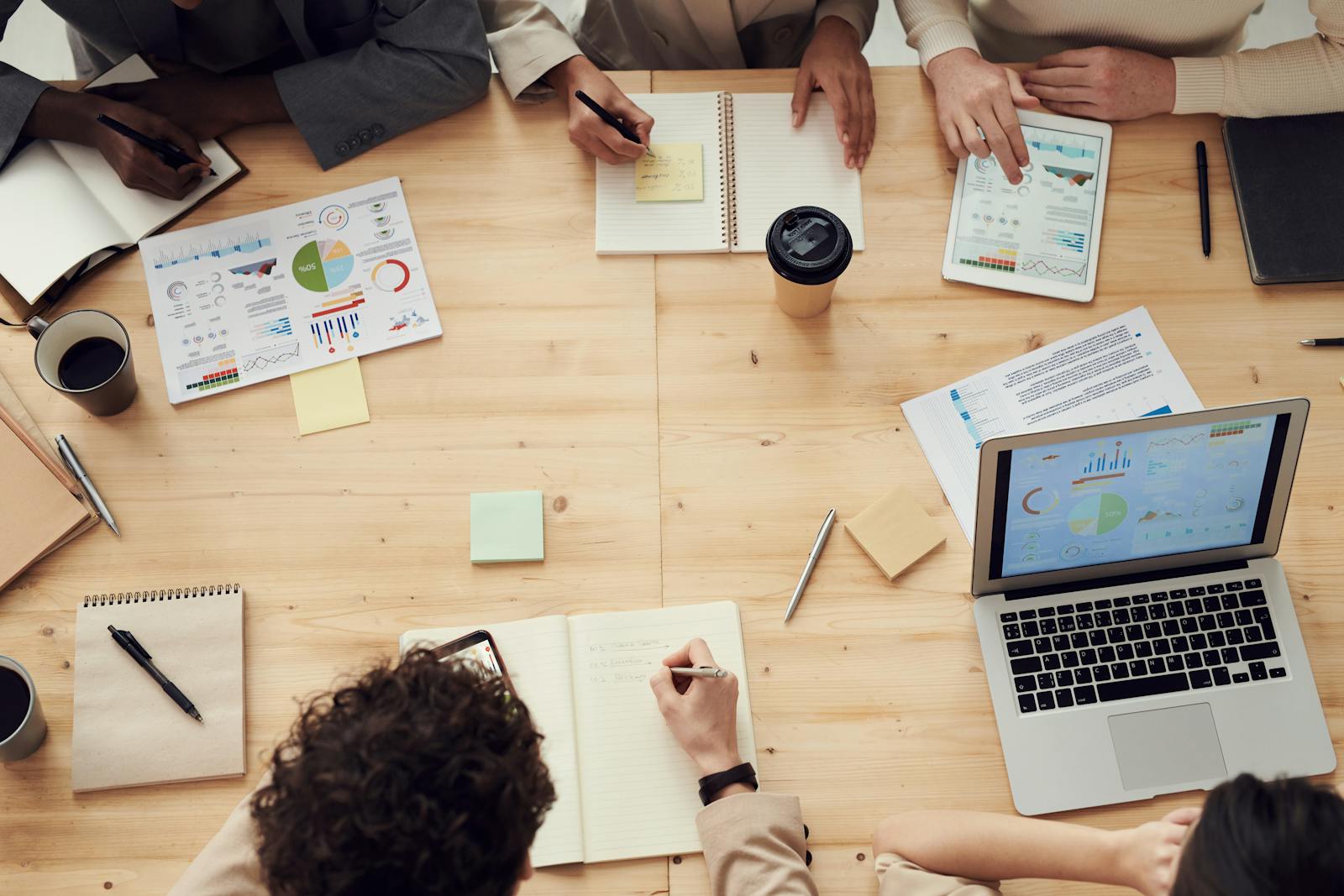 Remote professional working through admin workflow on laptop with headset